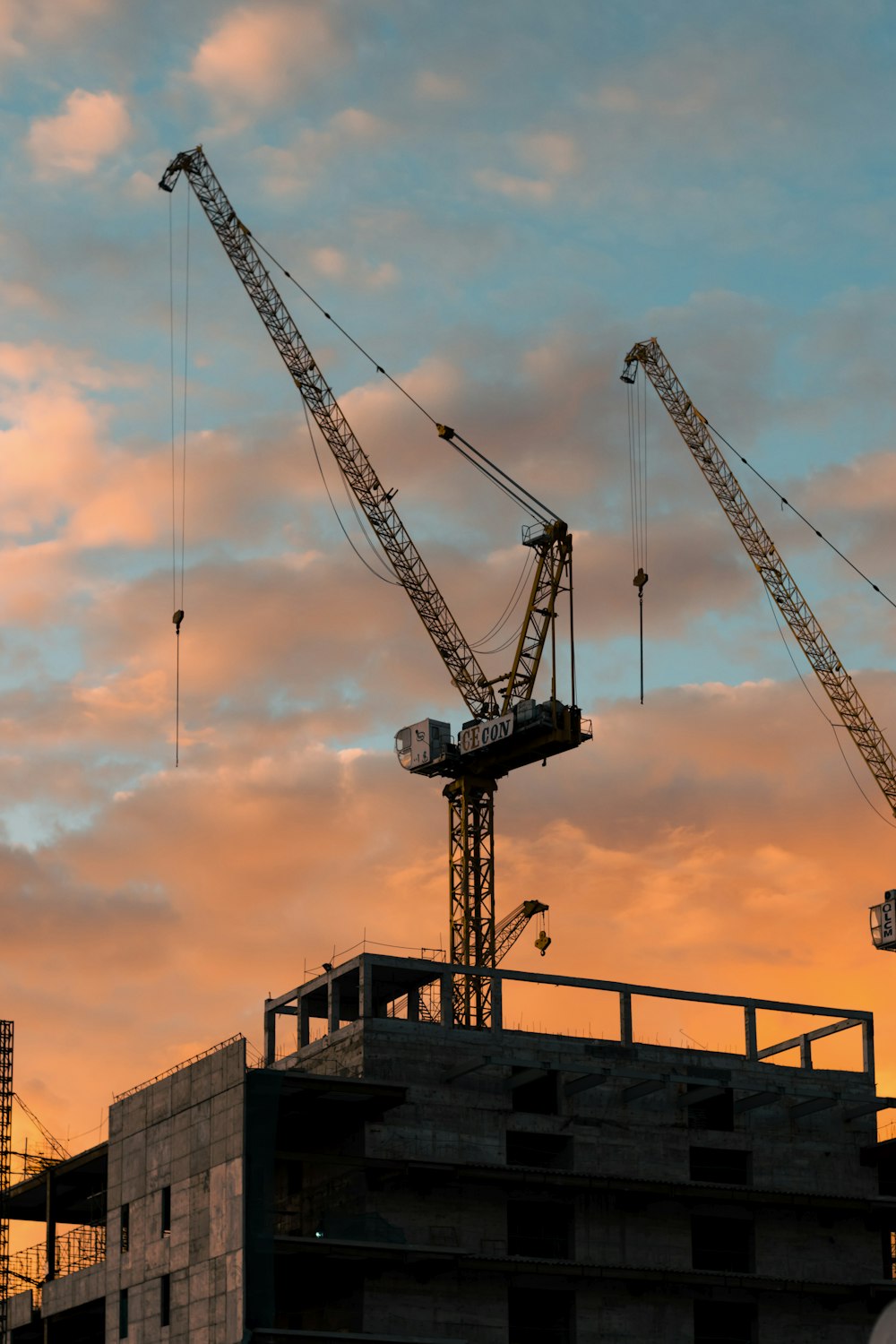 silhouette of crane under orange sky