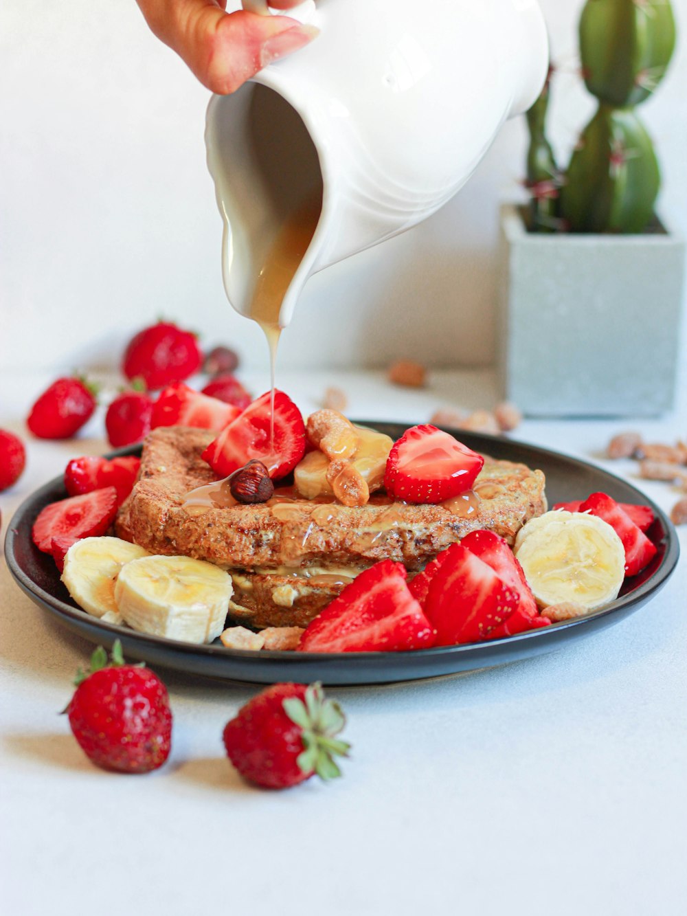 sliced strawberry and bread on white ceramic plate