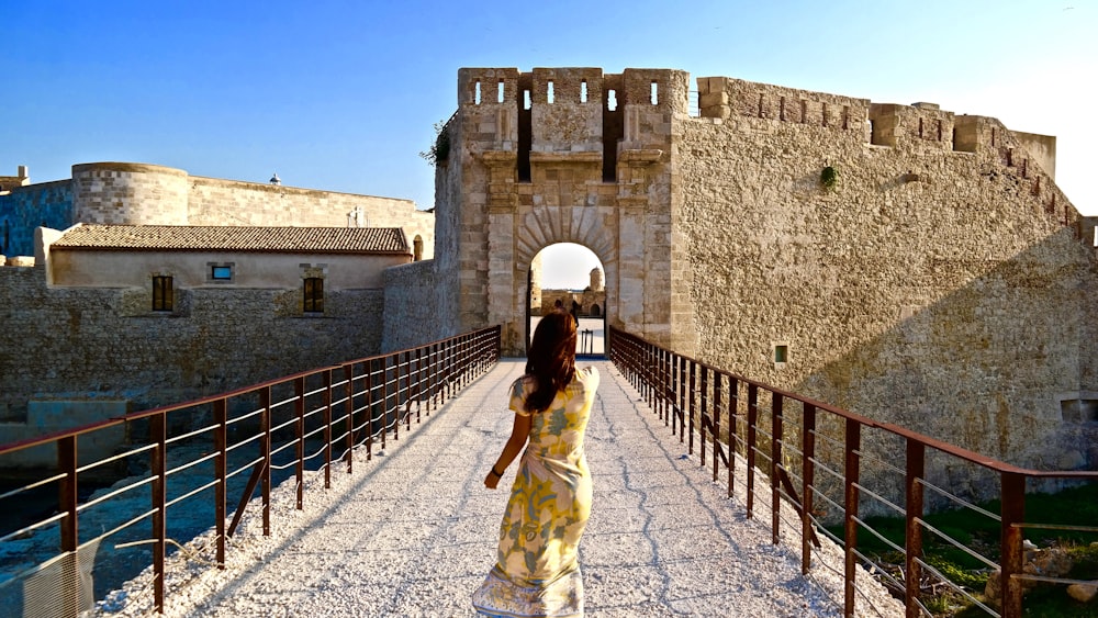 woman in white dress standing on gray concrete floor during daytime