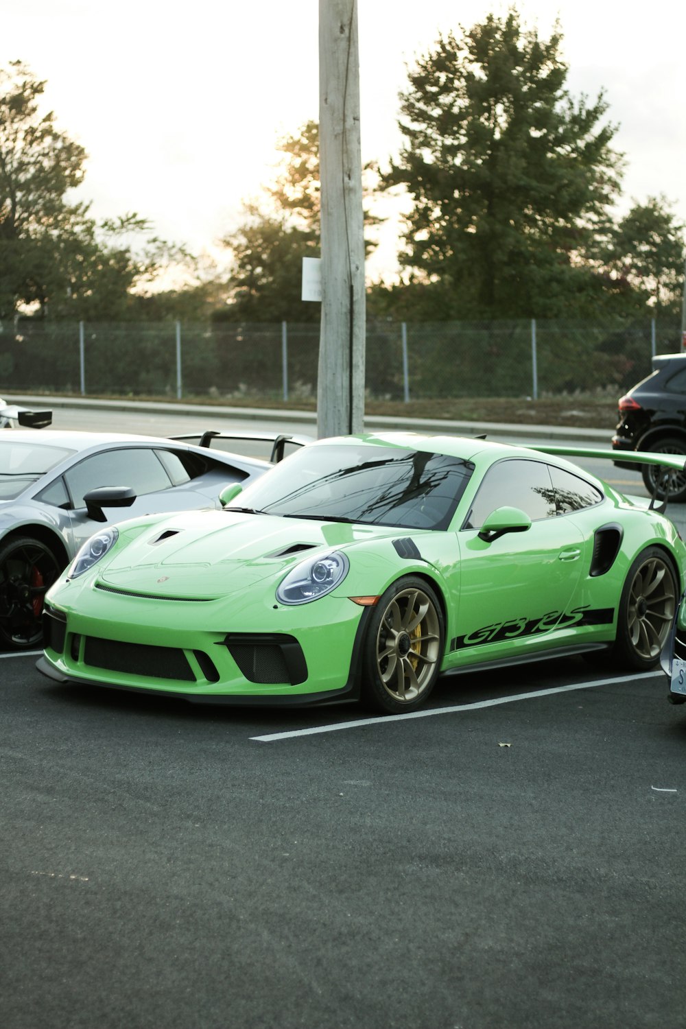 green and black porsche 911 on road during daytime