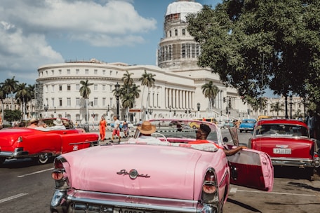 red convertible car parked on street during daytime