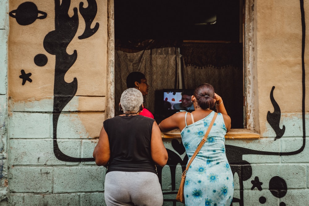 man in black t-shirt and woman in blue tank top kissing