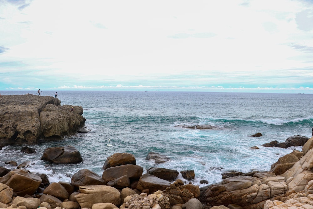 brown rocks on sea shore during daytime