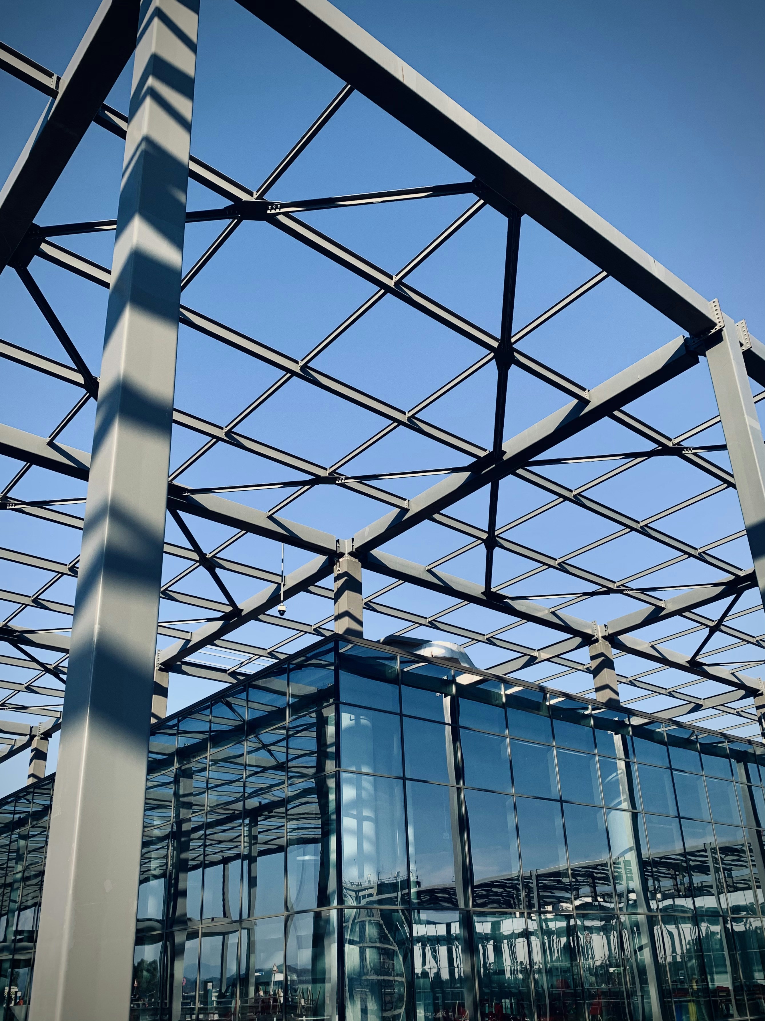 Completed modern commercial building with steel framework and professional finishes, dramatic sky