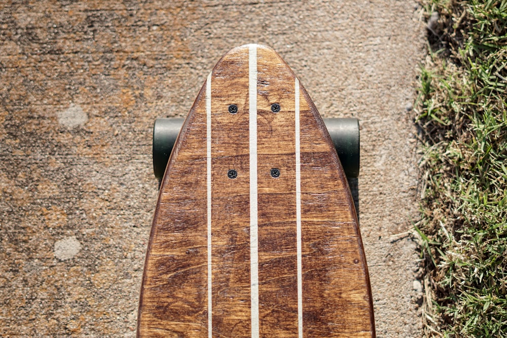 brown wooden guitar pick on brown and black surface