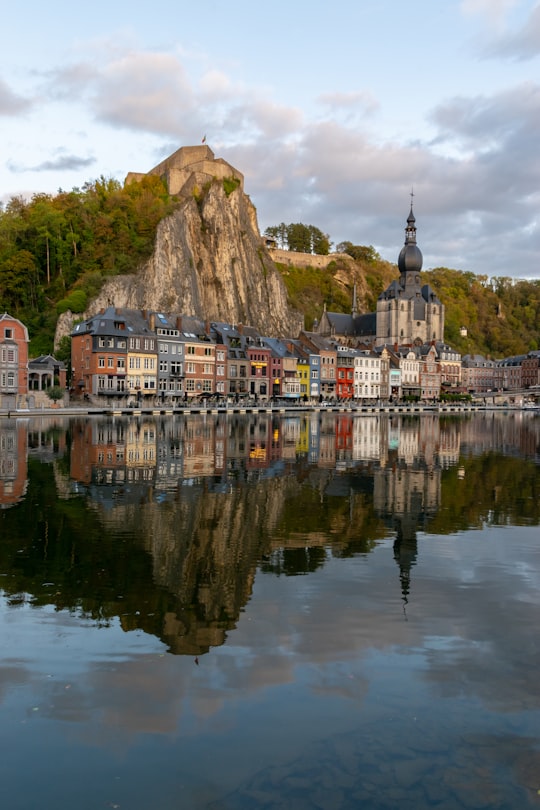 white and brown concrete building near body of water during daytime in Dinant Citadel Belgium