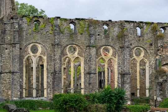 grey concrete building under white sky during daytime in Villers Abbey Belgium