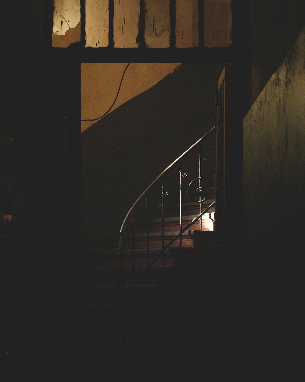 black metal staircase in dark room