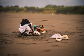Close-up of recovery tools arranged with elegant simplicity on a warm sand backdrop.