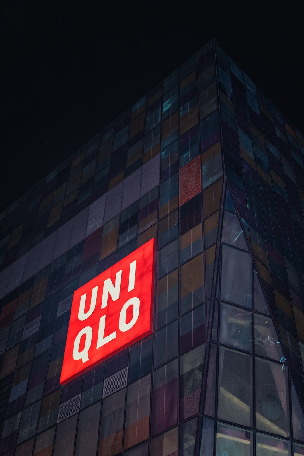 a tall building with a red sign on the side of it