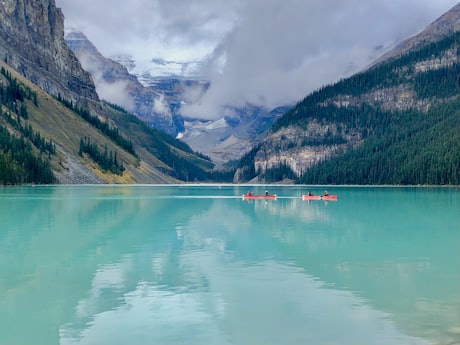 The Canadian Rockies - Canoes on Lake Louise with the glacier beyond