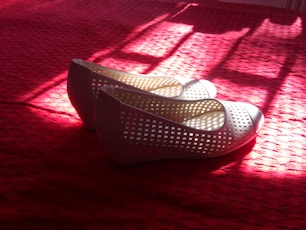 white and red flats on red textile