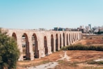 brown concrete bridge under blue sky during daytime