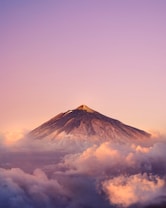 brown mountain under white clouds during daytime