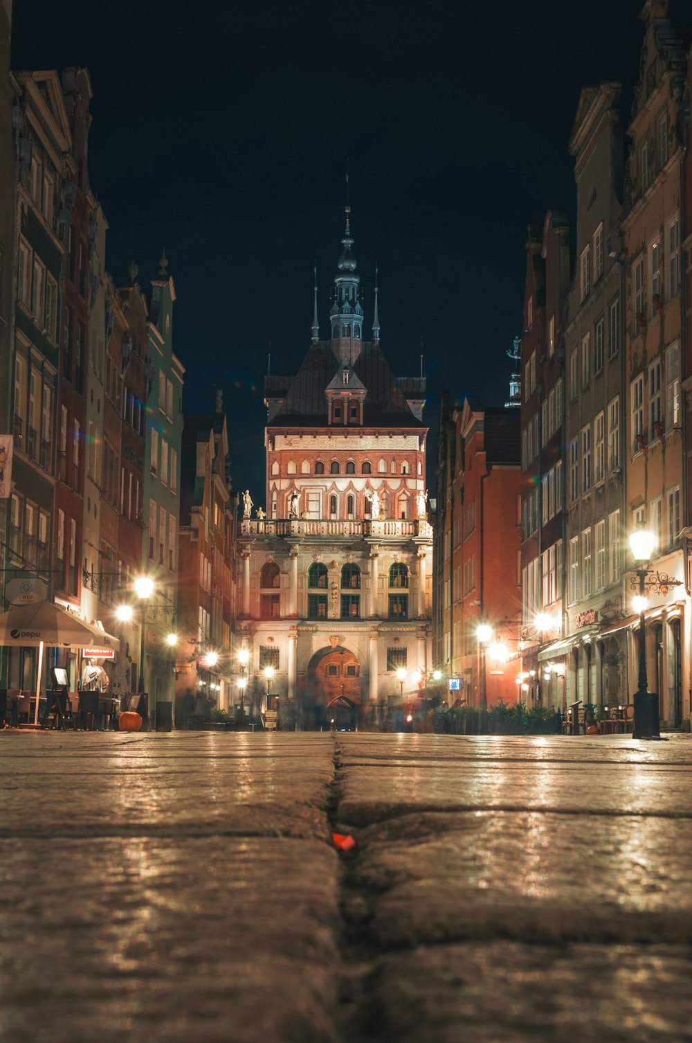 people walking on street near brown concrete building during nighttime