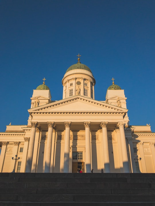 white concrete building under blue sky during daytime in Helsinki Cathedral Finland