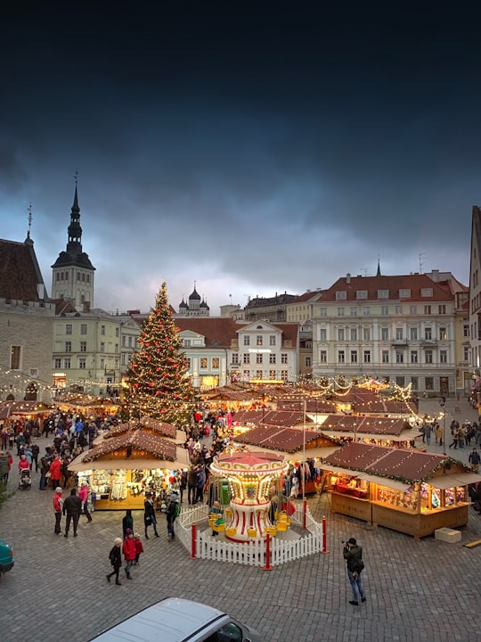 people walking on street near buildings during daytime in Town Hall Square Estonia