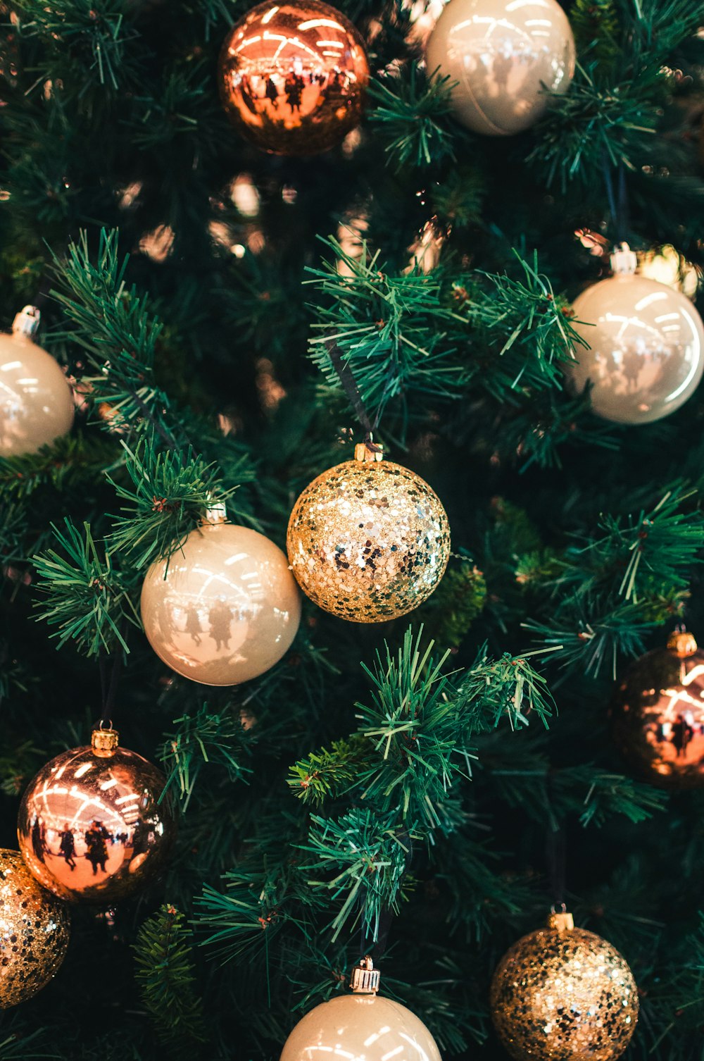 silver baubles on green christmas tree