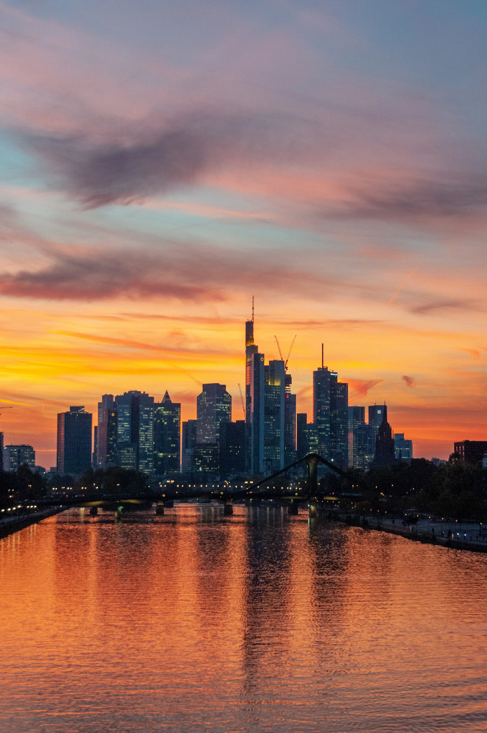 Frankfurt skyline reflected in the Main River at sunset, where many Canadians start a Germany trip with an eSIM