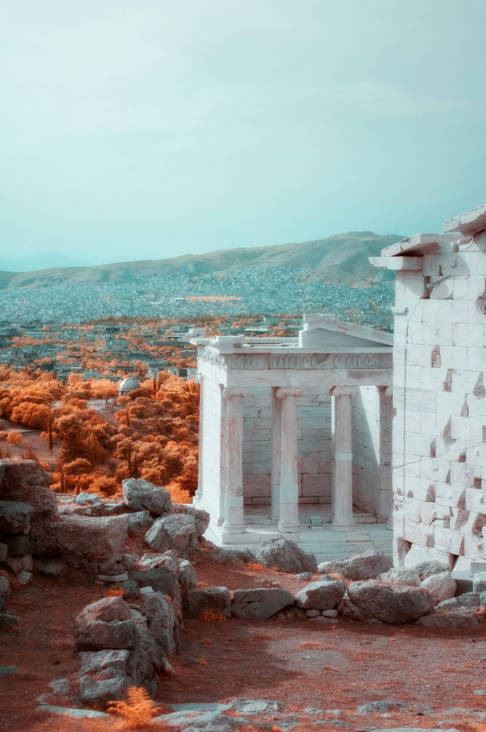 white concrete building on brown rocky mountain during daytime