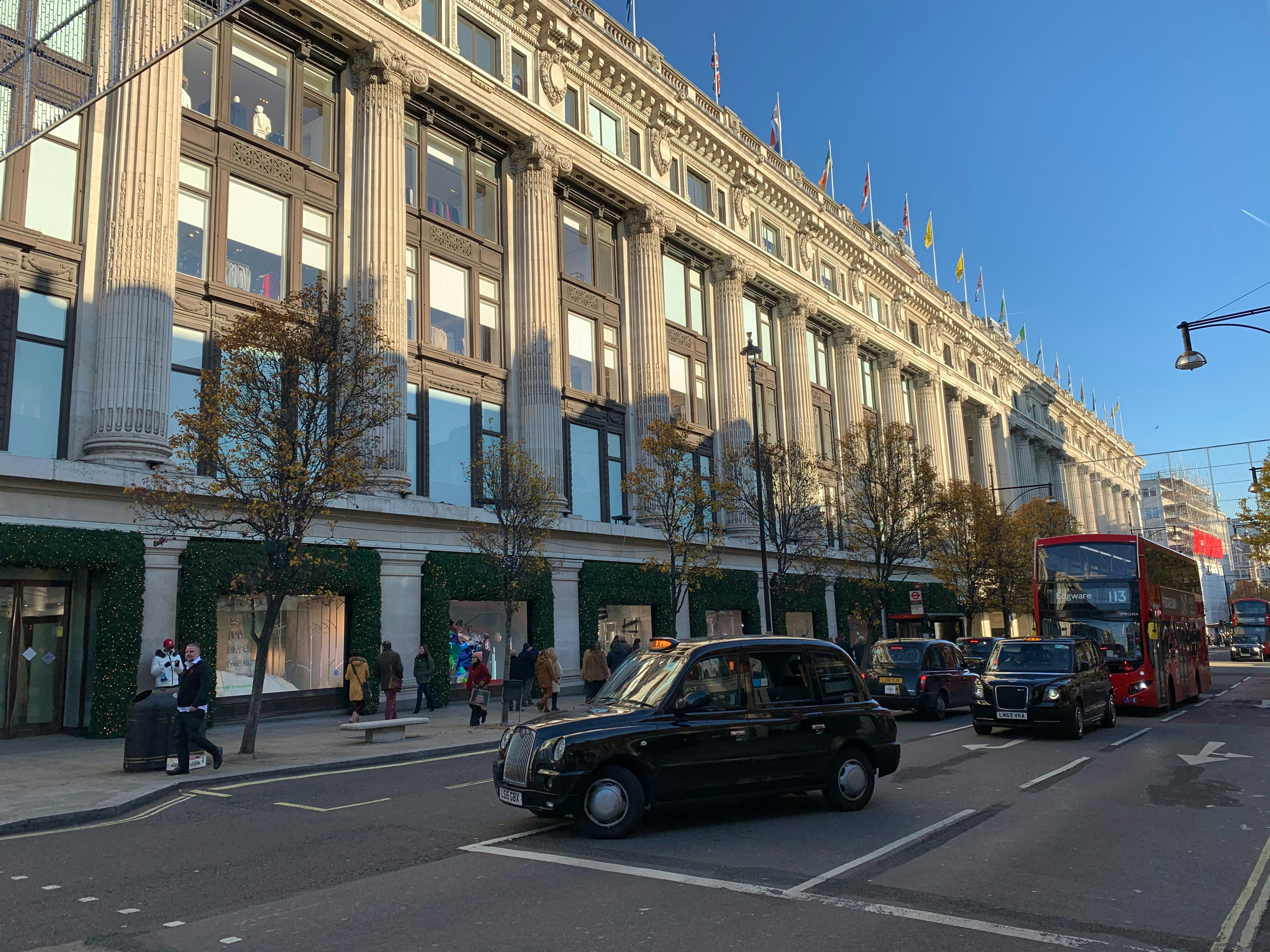 cars parked in front of beige concrete building during daytime