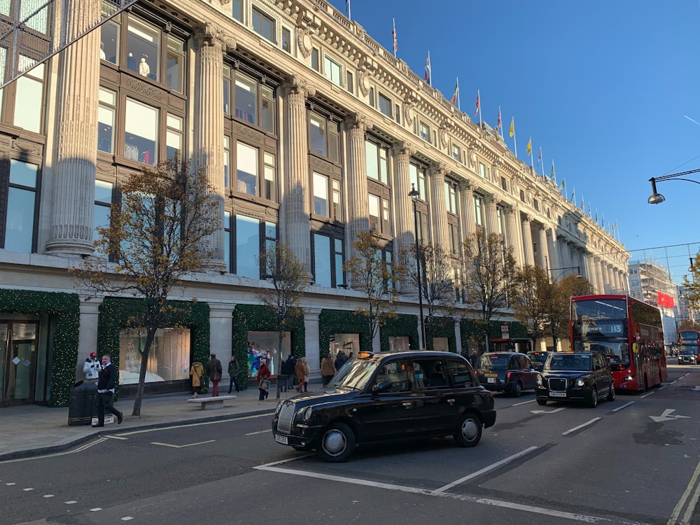 cars parked in front of beige concrete building during daytime