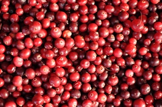 red round fruits on white surface