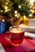 A cozy mug featuring a personalized photo and text, steaming with fresh coffee inside.