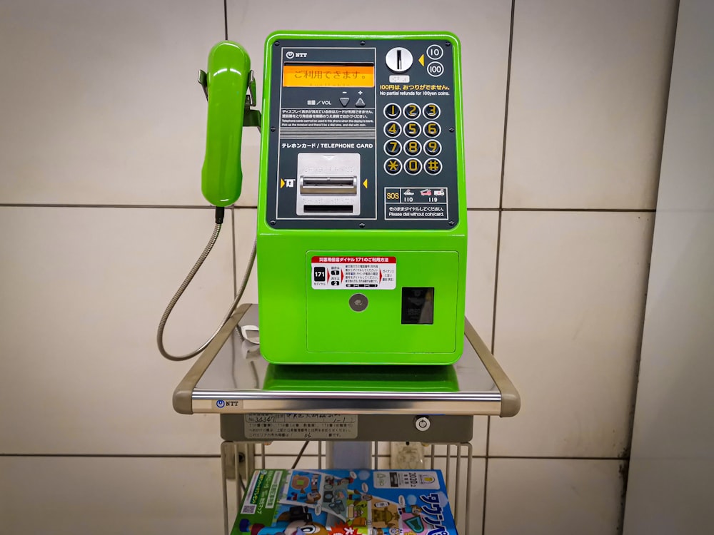 green and yellow telephone booth