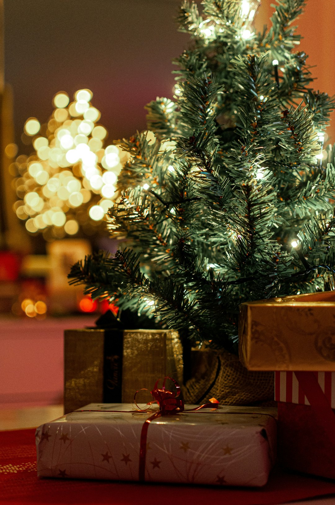 green christmas tree with baubles and gift boxes