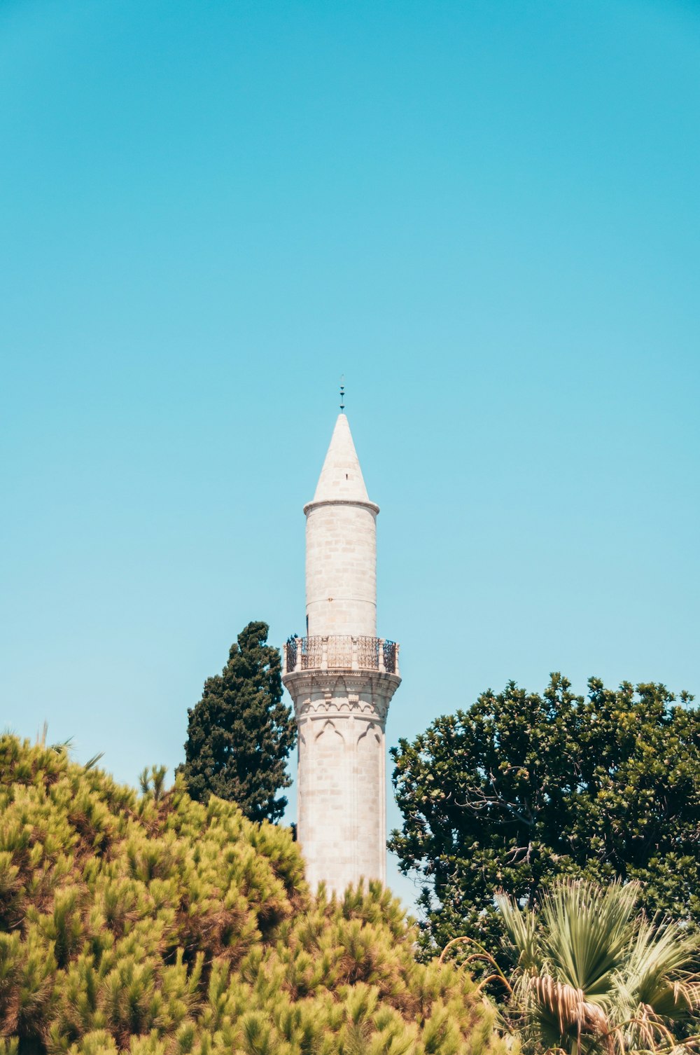 white concrete tower under blue sky during daytime