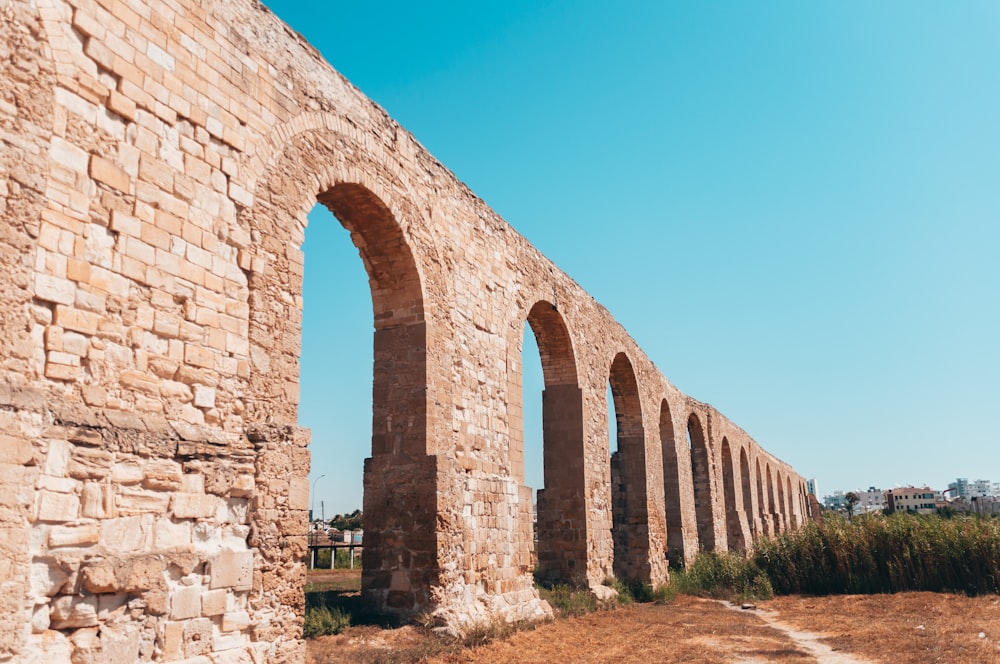 brown brick arch under blue sky during daytime