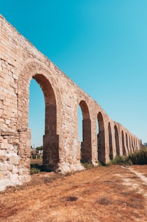 brown brick arch under blue sky during daytime
