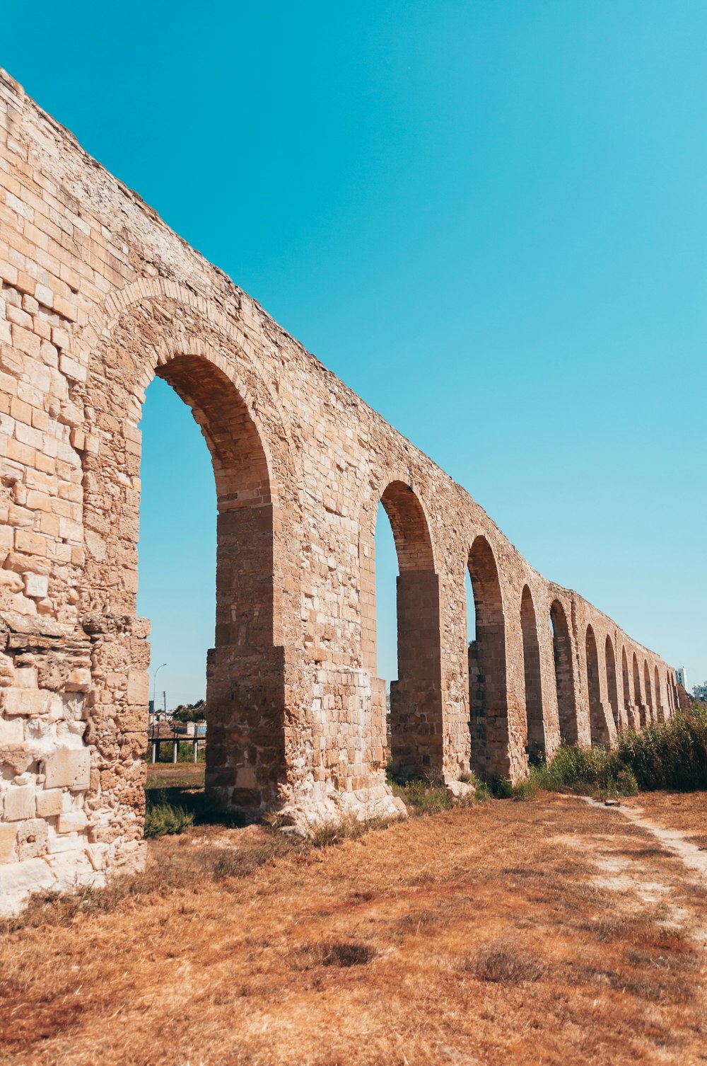 brown brick arch under blue sky during daytime