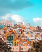 Colorful houses on the hills of La Boca neighborhood in Buenos Aires under a bright sky.