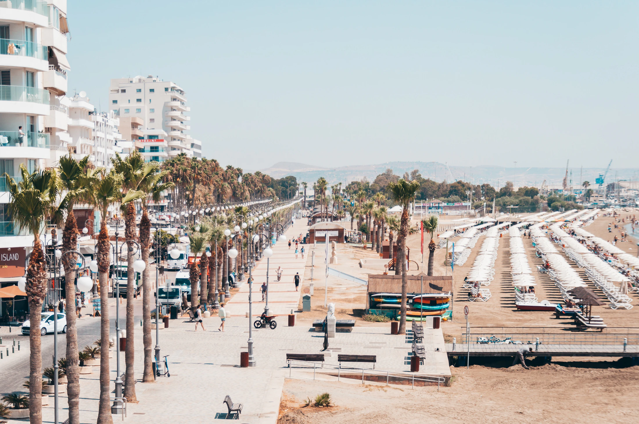 Beach and palm-lined waterfront buildings in Larnaca, Cyprus