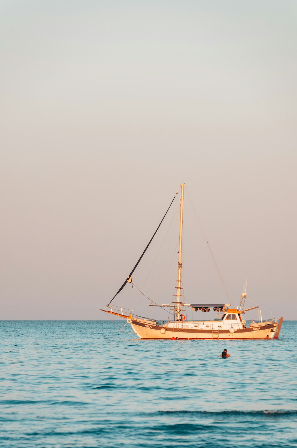 white and brown boat on sea during daytime