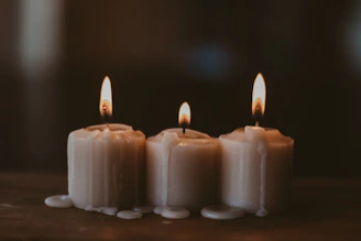 white candles on black surface