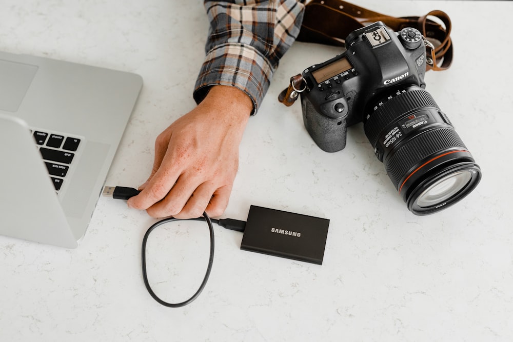 person holding black nikon dslr camera