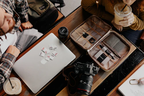 Close-up shot of a creator's workspace with laptops, notes, and product samples ready for collaboration.