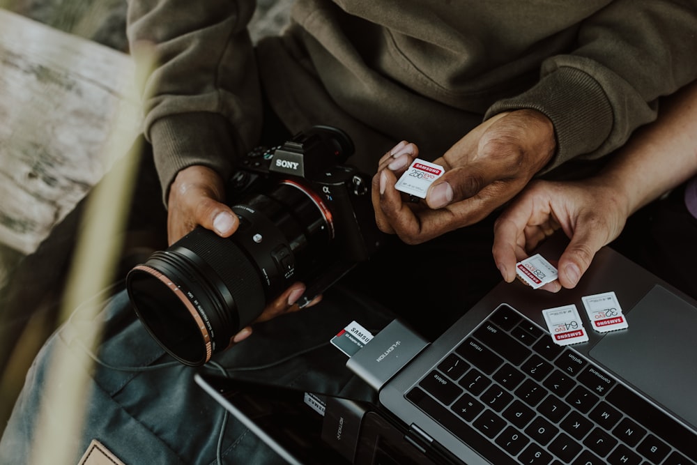 person holding black canon dslr camera