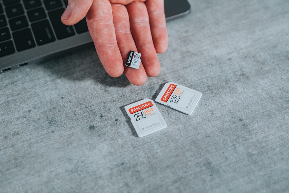 person holding white and black labeled card