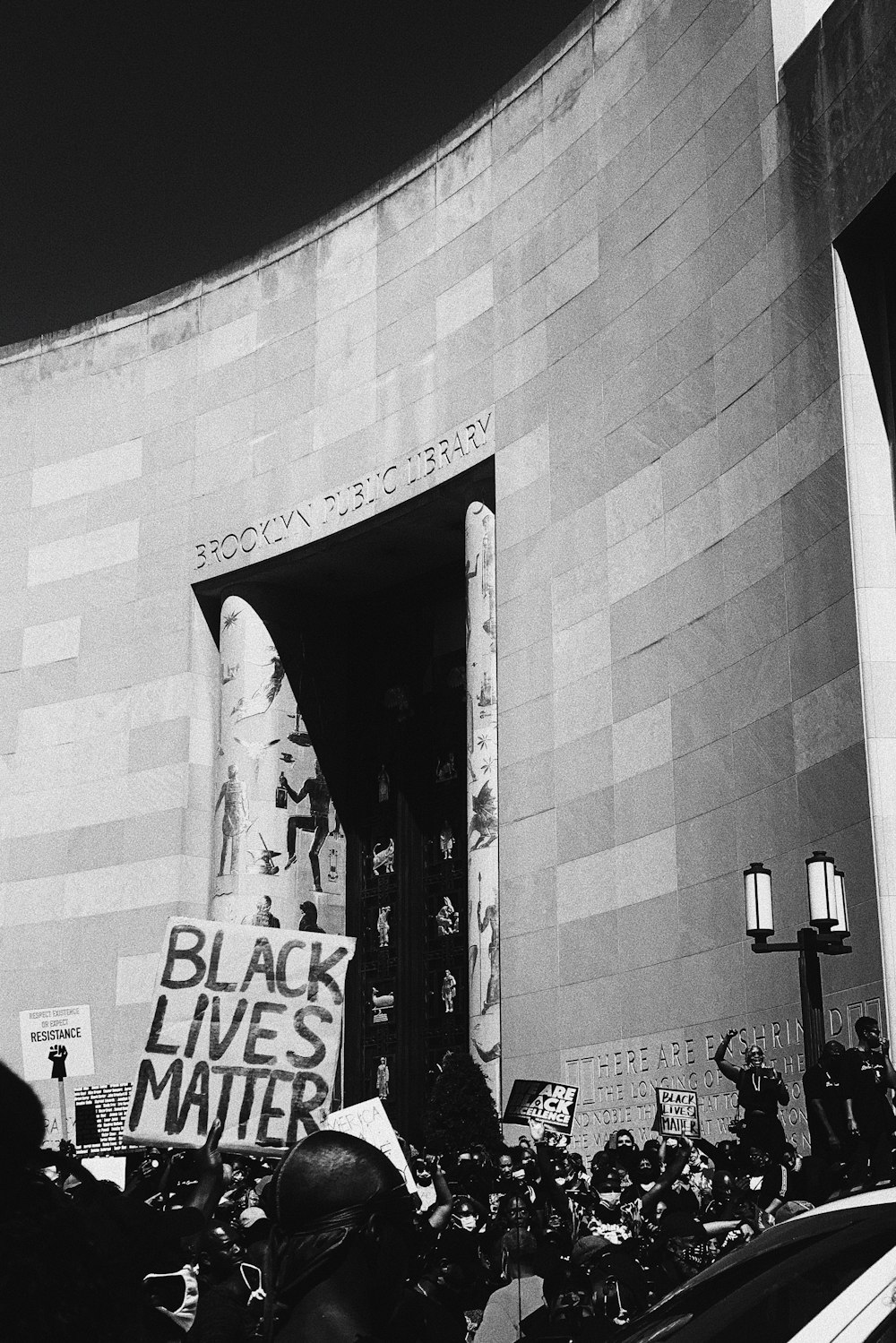 a black lives matter protest in front of a building