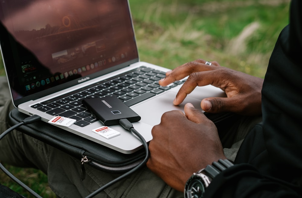 person using gray asus laptop computer