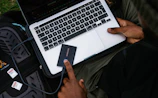 person holding silver and black laptop computer