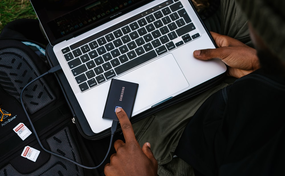 person holding silver and black laptop computer