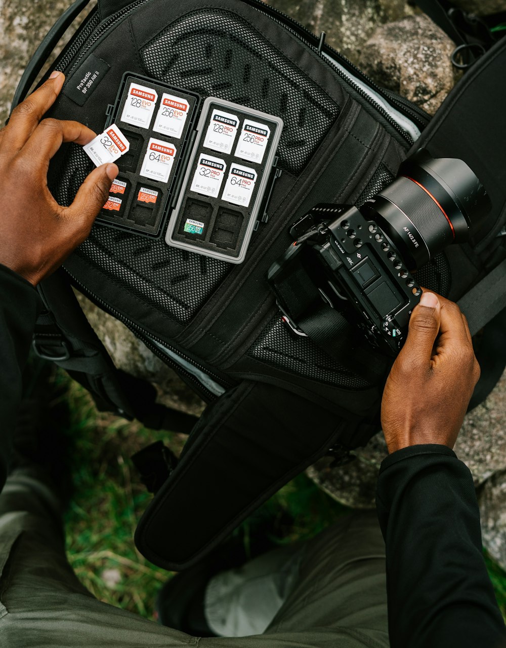 person holding black dslr camera