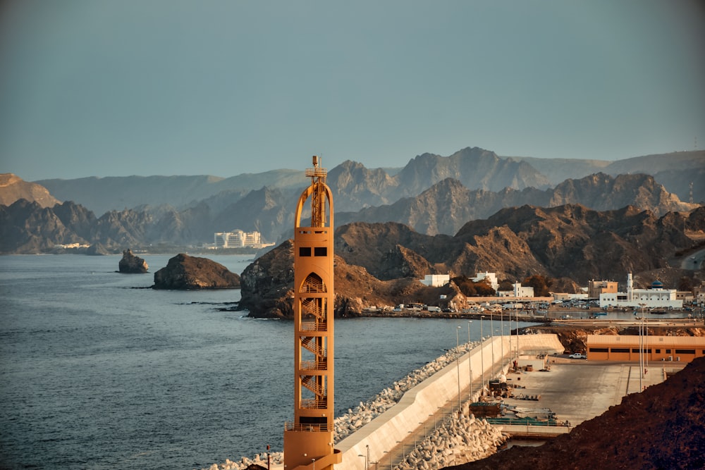 brown tower near body of water during daytime