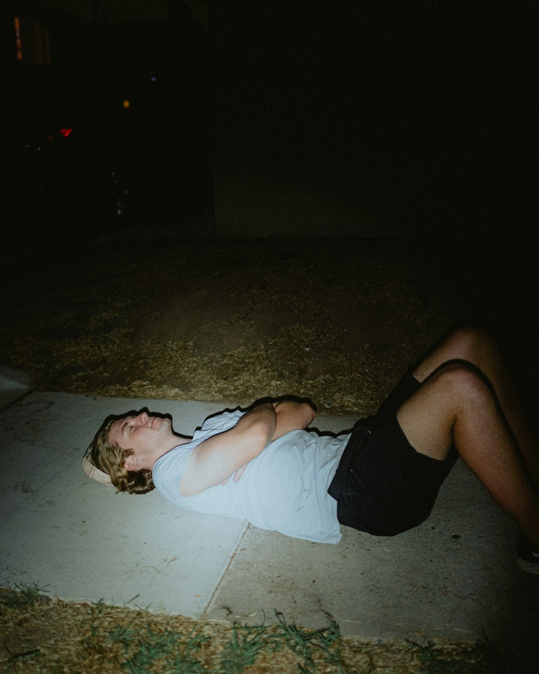 woman in white tank top lying on floor