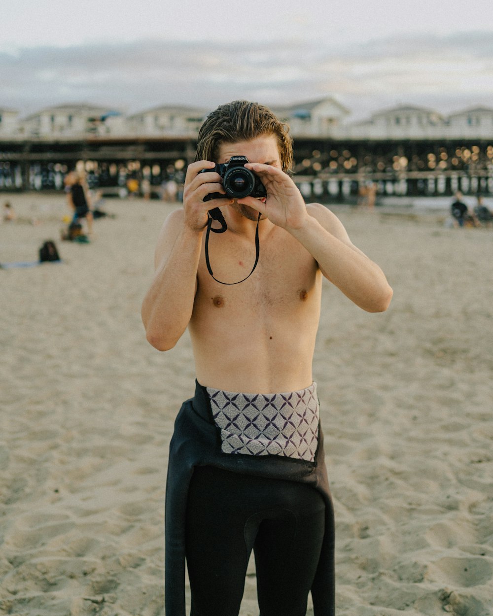 man in black shorts holding black camera